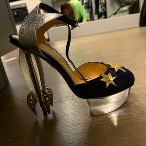 Navy suede with gold stars front, heel looks like a cool rocket in lucite heel